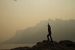 © ReeL - silhouette of person standing on top of mountain