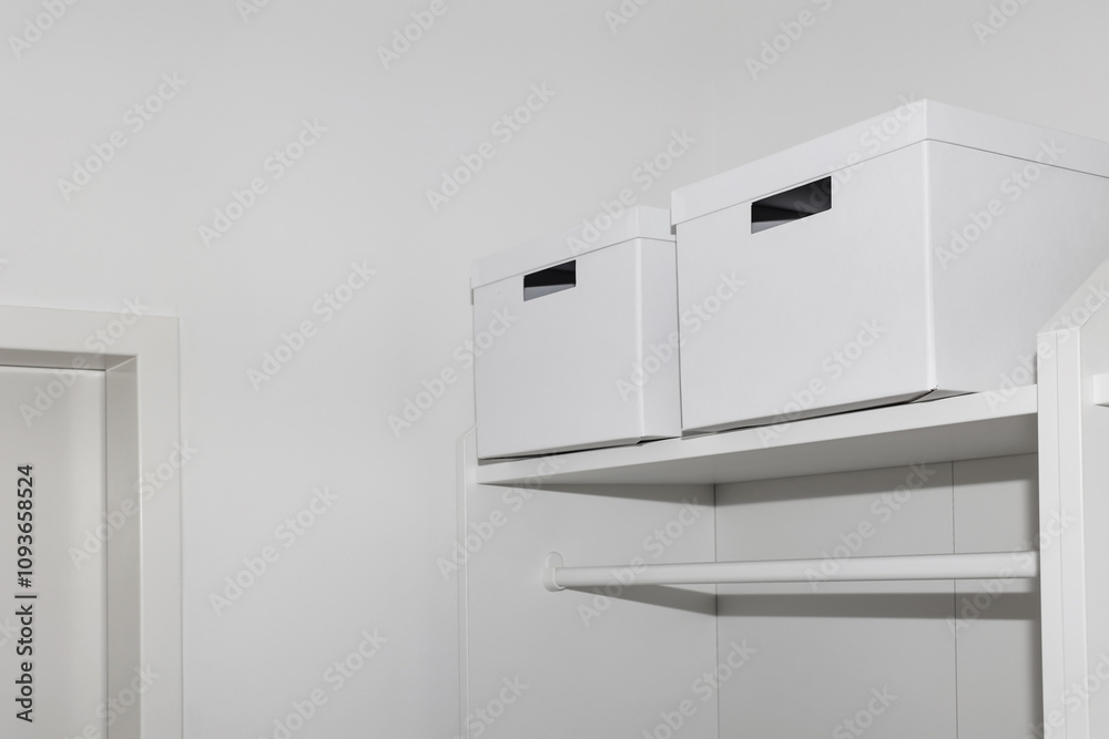 Boxes on shelf in light wardrobe