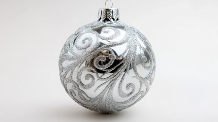 Poster - A single silver Christmas ornament with swirling designs on a white background.