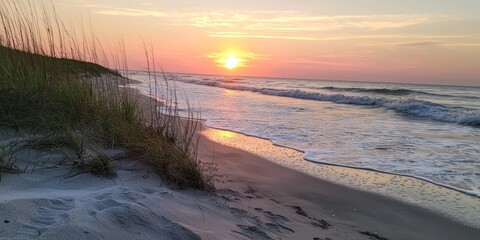 Poster - Sunset Over a Sandy Beach with Grass and Waves