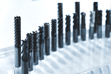 Poster - A row of metal tools are on a table. The tools are all different sizes and shapes. Some of the tools are long and thin, while others are short and wide