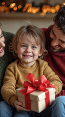 Wall Mural - happy child sitting with parents and big new year gift with big bow against new year interior background  and gold 2025 