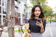© DG PhotoStock - Asian businesswoman walking on the street in city.