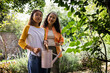 © Wavebreak Media - Gardening outdoors, grandmother and asian female teenager holding watering can, smiling together