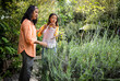 © Wavebreak Media - Grandmother and asian female teenager watering plants together in lush garden, enjoying nature