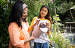 © Wavebreak Media - asian female teenager watering plants with grandma in garden, sharing joyful gardening moment