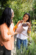 © Wavebreak Media - asian female teenager watering plants with grandmother in garden, sharing joyful moment together