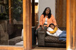 © Wavebreak Media - Asian emale teenager and grandmother sitting on couch at home, sharing comforting moment