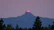 © Bethany - mountains dominating backdrop, trees populating the foreground, a red sun atop the peak