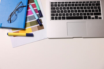 Poster - Designer's workplace with laptop and palette on white table, flat lay. Space for text