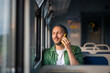 © DimaBerlin - Smiling man talk on phone with family, glancing out train window as arrival nears. Homecoming, male waiting for arrival, solo travel, tourism joy, mobile communication on road or business trip