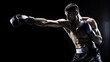 © arri - A muscular boxer throws a punch wearing black boxing gloves and shorts.