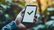 © Natcharat - A close-up of a hand holding a smartphone displaying an enrollment confirmation page with a green checkmark