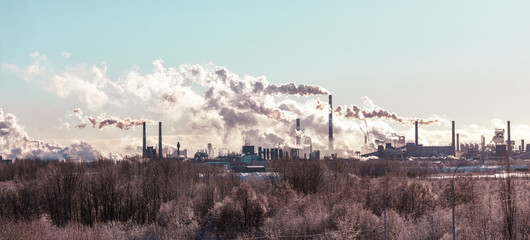 Wall Mural - A large industrial area with smoke and steam coming from the factories