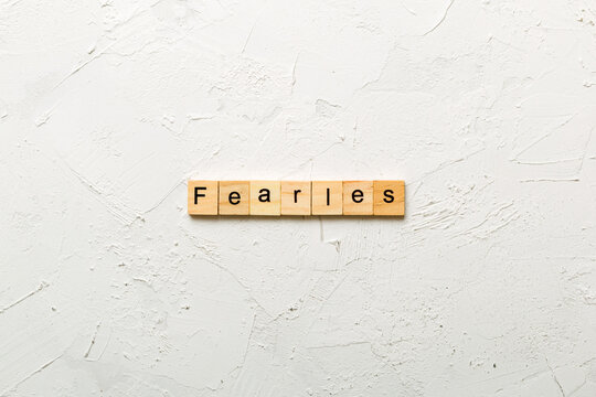 Fearless word written on wood block. Fearless text on cement table for your desing, concept