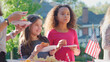 © Monkey Business - Teenage Girls At Outdoor Party Celebrating Independence Day In Garden Eating Pizza Together