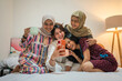 © Odua Images - A joyful gathering of friends sharing laughter and making memories at home, creating coziness