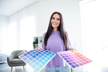 Wall Mural - Young woman smiling with colorful palette in daylight living room interior