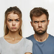 © rakT - A man and woman display displeased expressions, showcasing emotions of frustration or disappointment against a plain background.