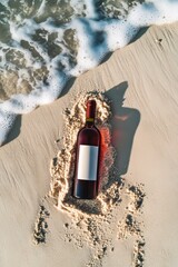 Wall Mural - A wine bottle rests on sunlit sand with ocean waves approaching, creating a contrast between leisure and nature's beauty.