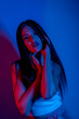 © FATIR29 - High Fashion model woman in colorful bright neon blue and purple lights posing in studio. Portrait of beautiful woman with trendy glowing make-up. Art design vivid style