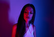 © FATIR29 - High Fashion model woman in colorful bright neon blue and purple lights posing in studio. Portrait of beautiful woman with trendy glowing make-up. Art design vivid style