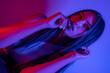 © FATIR29 - High Fashion model woman in colorful bright neon blue and purple lights posing in studio. Portrait of beautiful woman with trendy glowing make-up. Art design vivid style