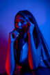 © FATIR29 - High Fashion model woman in colorful bright neon blue and purple lights posing in studio. Portrait of beautiful woman with trendy glowing make-up. Art design vivid style