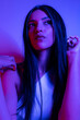 © FATIR29 - High Fashion model woman in colorful bright neon blue and purple lights posing in studio. Portrait of beautiful woman with trendy glowing make-up. Art design vivid style