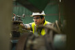 © iammotos - industrial Engineer indian man control lathe machine in industry manufacturing large factory . asian india labor worker male in hard hat and goggles working metal work in workplace . banner copy space