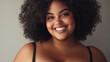© ArtBox - Smiling plus size model with large bust in studio