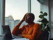 © Amy - Stressed Businesswoman in Modern Office, Touching Head in Frustration