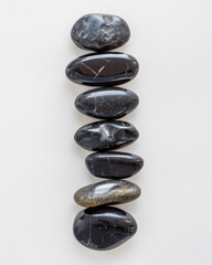 Poster - Arranging smooth black pebbles symmetrically on a clean white surface minimalist art indoor decor high-contrast aesthetic nature-inspired design