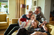© Marko Geber - Group of senior friends laughing while taking selfie together at home