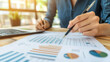 © Neural Canvas - Analyzing financial reports with graphs and charts in office