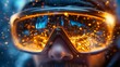 © Vertigo Images - Close-up of a man's face partially obscured by protective goggles, reflecting a fiery, intense light show.  The image is dynamic and full of energy.