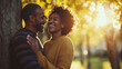 © Oran - joyful couple sharing moment of laughter in sunlit park, surrounded by trees. Their smiles radiate happiness and love