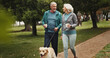 © peopleimages.com - Coffee, old couple and walking dog in park together for outdoor fitness, health or wellness. Exercise, hobby or smile with senior man and woman training pet Labrador in nature for animal obedience