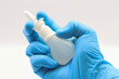 © TopMicrobialStock - Doctor's hand with a nose spray. Respiratory infections. Nasal vaccine.