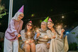 © Odua Images - A joyful gathering of friends celebrating under the stars with colorful sparklers at night