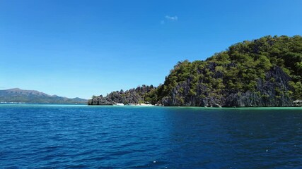 Wall Mural - tropical philippines island, view from moving boat. white sand beach, rocks cliffs mountains and blu