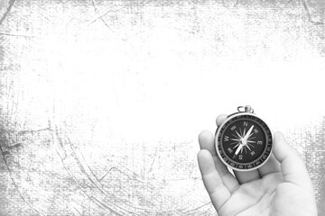 Wall Mural - round compass in hand on abstract background