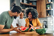 © Lumos sp - child family kitchen food boy son father mother watermelon fruit slice summer organic meal fun preparing healthy diet eating home black