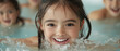 © Lifestyle Images - A young girl is smiling and splashing in a pool