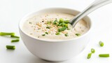 A bowl of creamy sesame ginger dressing garnished with sesame seeds and green onions, Each spoonful flavorful and aromatic