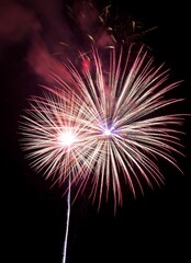 smoky, red fireworks exploding in night sky