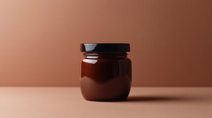 Poster - A Brown Glass Jar with a Black Lid on a Light Brown Background