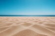 Tranquil Beach and Calm Ocean Under Clear Blue Sky with Gentle Ripples in Sand