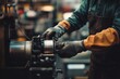 © Space Priest - Caucasian male adult operating industrial machinery in workshop