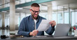 © Andrey Popov - Shocked Young Businessman Reading Document At Desk